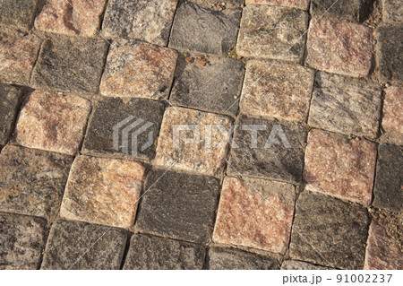 Pavement of grey and white stone plates, looks like a chess bord.the background square paving stones like chess 91002237