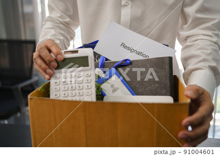 Resignation concept, Male employee packing personal belonging and resignation letter in the box Resignation concept, Male employee packing personal belonging and resignation letter in the box 91004601