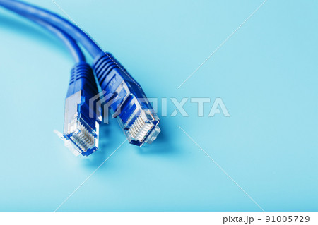 Ethernet Cable connector Patch cord cord close-up on a blue background with free space Ethernet Cable connector Patch cord cord close-up on a blue background with free space 91005729