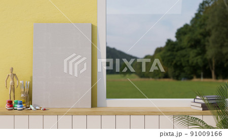 Blank empty canvas or poster mockup standing on the table against the yellow wall and window Blank empty canvas or poster mockup standing on the table against the yellow wall and window 91009166