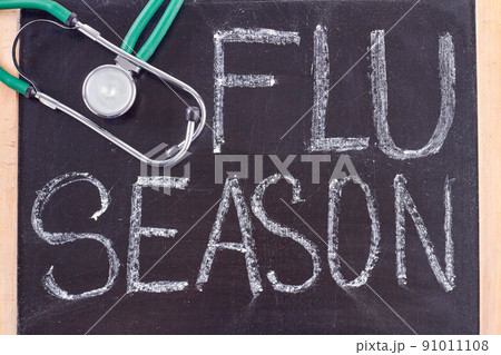 Blackboard with flu season handwriting and stethoscope. 91011108
