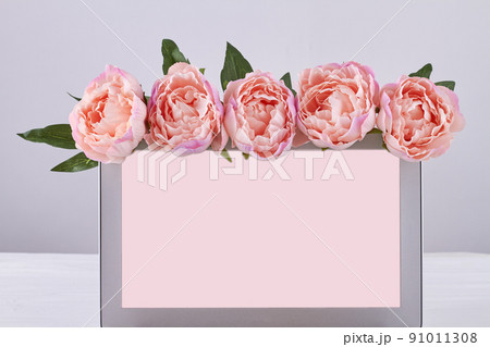 Laptop with blank screen decorated with pink flowers. 91011308