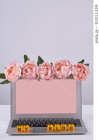 Laptop view pink screen for copy space decorated with flowers. 91011309