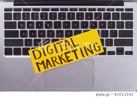 Keyboard with digital marketing words on yellow paper. 91011542