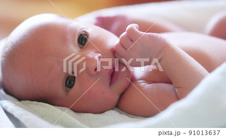 newborn. baby newborn a close-up lies looking lifestyle at the camera in the hospital maternity hospital. happy family baby dream concept. cute newborn baby wrapped in a blanket newborn. baby newborn a close-up lies looking lifestyle at the camera in the hospital maternity hospital. happy family baby dream concept. cute newborn baby wrapped in a blanket 91013637