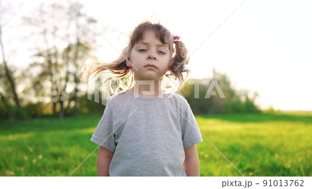 people in the park. portrait little girl outdoors. happy family kid dream concept. child a girl kid portrait sunlight close-up in the park glare. happy cute baby in summer outdoors close up portrait 91013762