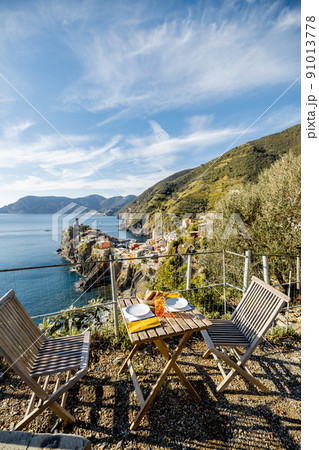 Served lunch table on the coast near Vernazza village in Italy Served lunch table on the coast near Vernazza village in Italy 91013778