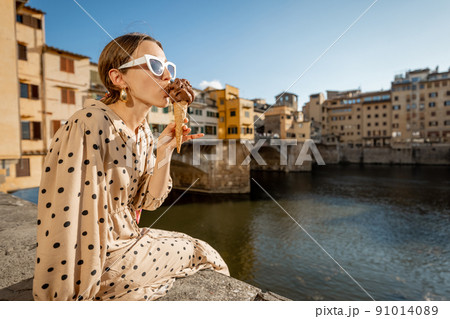 Woman with italian ice cream in Florence, Italy Woman with italian ice cream in Florence, Italy 91014089