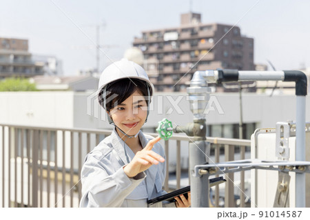 配管を点検する女性作業員 91014587