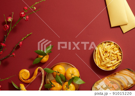 Tet holiday with mandarin orange candy jam , fried potato , flower and ang pao biscuit in golden dish , photography Tet holiday content Tet holiday with mandarin orange candy jam , fried potato , flower and ang pao biscuit in golden dish , photography Tet holiday content 91015220