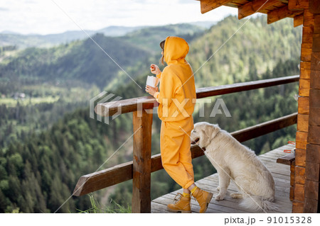 Woman enjoys great view on mountains during a lunchtime Woman enjoys great view on mountains during a lunchtime 91015328