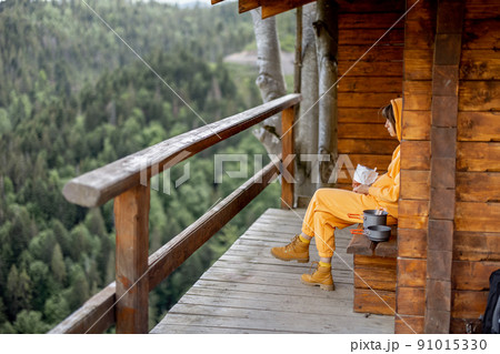 Woman enjoys great view on mountains at nature house 91015330