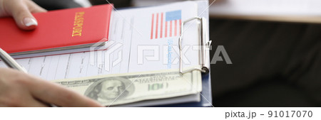 Person sitting in line with visa application forms to get access to enter country Person sitting in line with visa application forms to get access to enter country 91017070