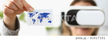 Young woman wearing virtual glasses and showing credit card 91017101