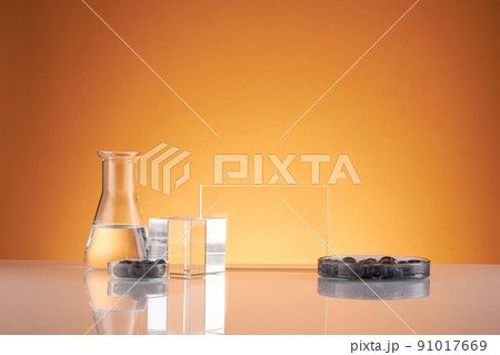 Front view of blueberry extract decorated with transparent podium and glassware blank space in brown background	 91017669