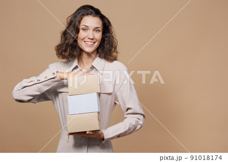 woman's hand holds cardboard boxes for delivery. food and clothing with home delivery. 91018174