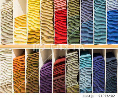 The colourful socks are arranged on the shelf for sale in a shopping mall. The colourful socks are arranged on the shelf for sale in a shopping mall. 91018402
