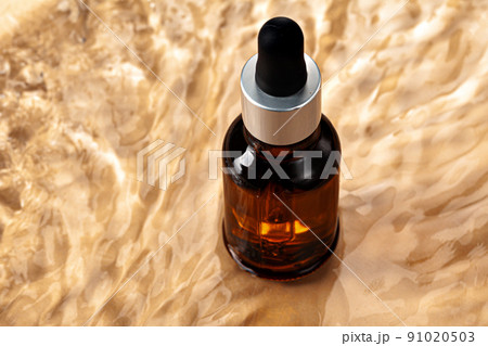 Oil cosmetic bottle on water waves background Oil cosmetic bottle on water waves background 91020503