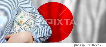 Us dollars on Japanese flag background Us dollars on Japanese flag background 91022475