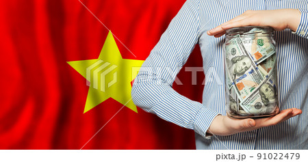 100 US dollars banknotes in glass jar and flag of  Vietnam 91022479