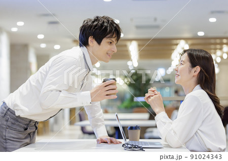 談笑をする男女　オフィス　会話 91024343