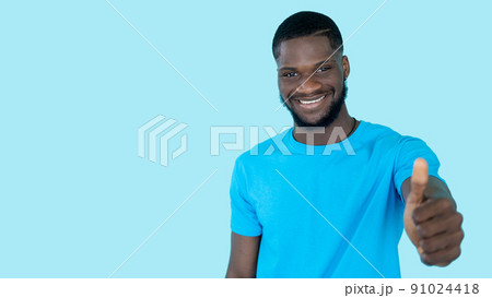Like gesture. Positive feedback. Good offer. Happy smiling man showing thumbs up approval isolated on blue copy space banner background. Like gesture. Positive feedback. Good offer. Happy smiling man showing thumbs up approval isolated on blue copy space banner background. 91024418