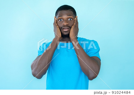 Scared man. Fear expression. Anxiety stress. Problem panic. Worried afraid shocked guy portrait isolated on blue studio background. Scared man. Fear expression. Anxiety stress. Problem panic. Worried afraid shocked guy portrait isolated on blue studio background. 91024484