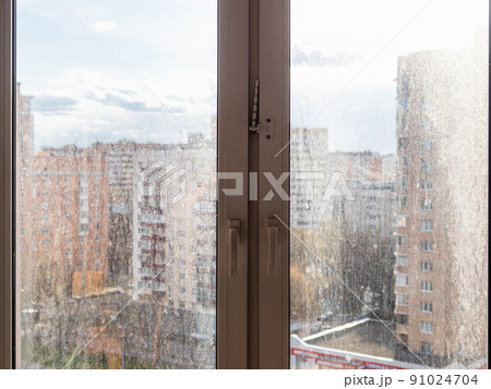 cityscape view through dirty window glass at home cityscape view through dirty window glass at home 91024704