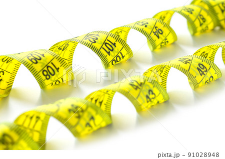 Yellow measuring measure tape isolated on white background 91028948