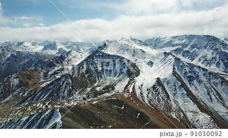 Mountain tops covered with snow. View from a drone Mountain tops covered with snow. View from a drone 91030092