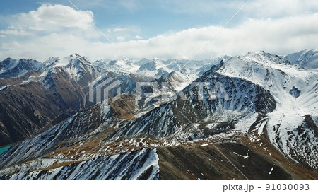 Mountain tops covered with snow. View from a drone Mountain tops covered with snow. View from a drone 91030093