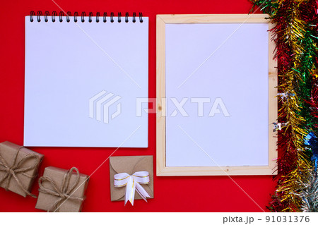 Note book and Christmas gift box on red background. 91031376