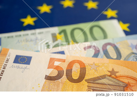Euro banknotes on EU flag, finance and accounting, banking concept. 91031510