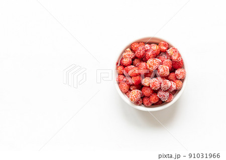 Frozen red wild forest strawberry in white bowl on white background with copy space for text. Freezing berries are healthy, they contains all vitamins. Top view. Horizontal orientation. 91031966