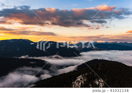 Cloudy skies over the mountains, rainy spring clouds over the forest and mountain tops. Cloudy skies over the mountains, rainy spring clouds over the forest and mountain tops. 91032138