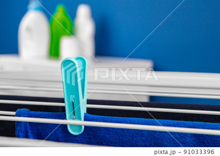 Clothes hanger rack dryer with clothespins close up Clothes hanger rack dryer with clothespins close up 91033396