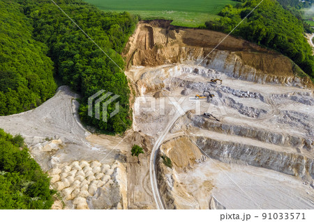 Open pit mining of construction sand stone materials with excavators and dump trucks. 91033571