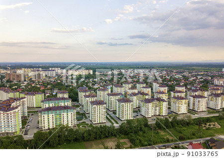 Top view of urban developing city landscape with tall apartment buildings and suburb houses. Drone aerial photography. Top view of urban developing city landscape with tall apartment buildings and suburb houses. Drone aerial photography. 91033765