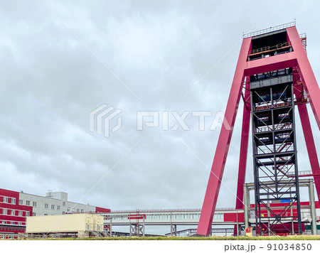construction site of an industrial complex. construction of a mine for mining. red metal structure for digging into a mine, digging a ditch 91034850