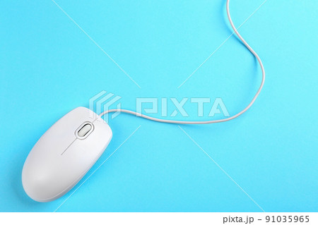 Modern wired mouse on light blue background, top view 91035965