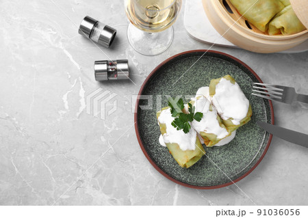 Delicious cabbage rolls served on grey marble table, flat lay. Space for text Delicious cabbage rolls served on grey marble table, flat lay. Space for text 91036056