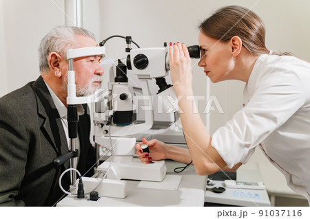 ophthalmologist examination of elderly man with slit lamp. medical equipment 91037116