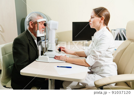 ophthalmologist examination of elderly man on corneo topographer.modern clinic 91037120
