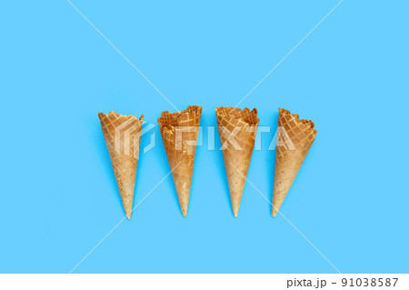 Empty ice cream cone on blue background. Empty ice cream cone on blue background. 91038587
