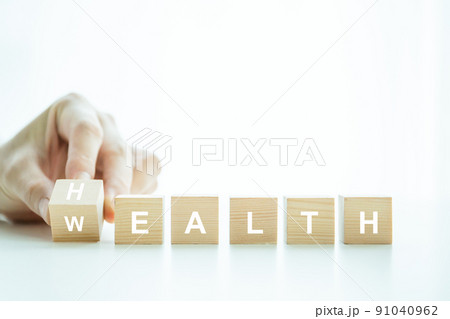 Words Health and Wealth on the wooden block close up, man turning the words between health and wealth. The conceptual of healthcare - wellbeing and security in financial. 91040962