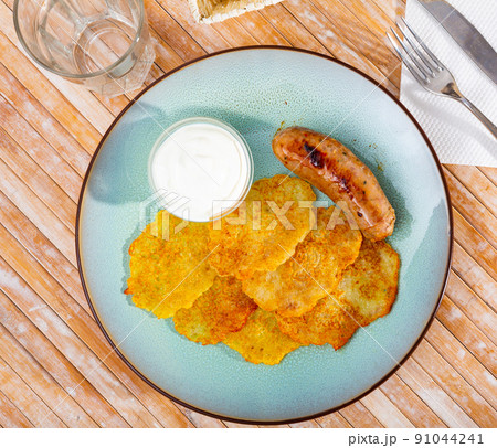 Potato pancakes with sausage and sour cream 91044241