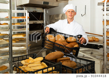 Portrait of baker with fresh bread at bakery 91044418
