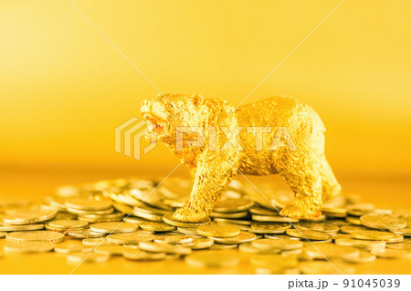 Bear walking over crypto coins against golden background. Market downtrend concept. Bear walking over crypto coins against golden background. Market downtrend concept. 91045039