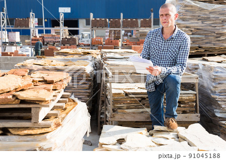 Man of hardware store keeps records of natural stone tiles Man of hardware store keeps records of natural stone tiles 91045188
