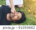 nurse giving cardiopulmonary resuscitation to man on grass park 91050662